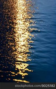 Horizontal shot of clear beautiful ocean with sun reflection