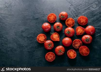 Horizontal shot of heirloom red tomatoes on dark background with copy space for your advertisement. Salad ingredients. Fresh vegetables