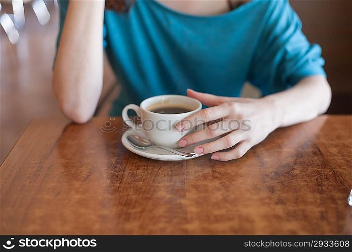 horizontal shot women in cafe, cup and heands part of the body shot, closeup