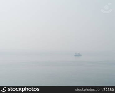 Horizontal sparse pale lonely ship in white ocean background backdrop. Horizontal sparse pale lonely ship in white ocean background bac