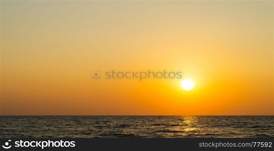 Horizontal vibrant orange ocean sunset background backdrop