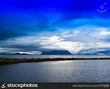 Horizontal vivid Norway fjord ocean bay with dramatic clouds background backdrop. Horizontal vivid Norway fjord ocean bay with dramatic clouds bac