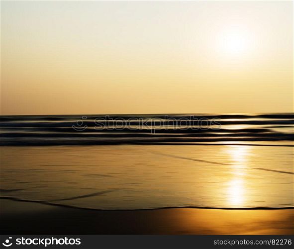 Horizontal vivid sunset ocean horizon tidal waves blur landscape background backdrop. Horizontal vivid sunset ocean horizon tidal waves blur landscape