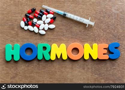 hormones colorful word in the wooden background