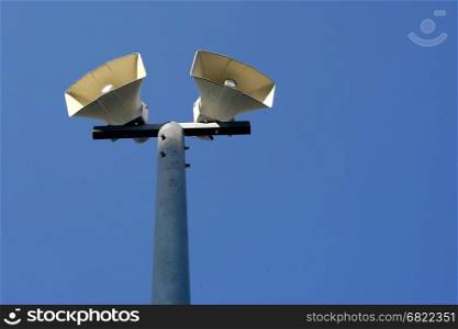 horn speaker on pole with blue sky background