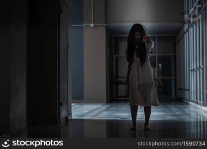 Horror evil woman ghost creepy in a dark room at house. The female devil is scary she haunted at the abandoned building, Happy Halloween day concept