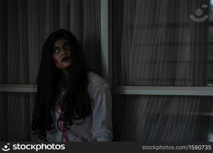 Horror evil woman ghost creepy in a dark room at house. The female devil is scary she haunted at the abandoned building, Happy Halloween day concept