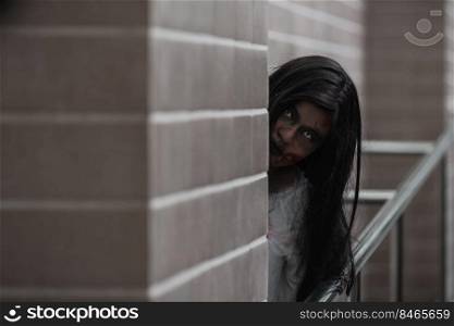 Horror evil woman ghost creepy in a dark room at house. Female zombie in blood devil is scary she haunted at the abandoned building, Happy Halloween festival day concept