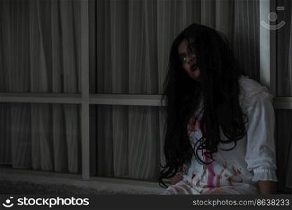 Horror evil woman ghost creepy in a dark room at house. The female devil is scary she haunted at the abandoned building, Happy Halloween day concept 