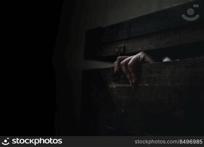 Horror ghost woman. Asian ghost horror creepy scary have hair covering face and eye lying in the old treasure chest, female makeup terror zombie face, murder, Closeup hand, Happy Halloween day concept