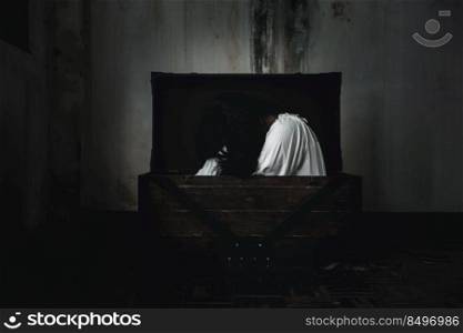 Horror ghost woman. Asian ghost horror creepy scary have hair covering face and eye lying in the old treasure chest, female makeup terror zombie face, murder, Happy Halloween day concept
