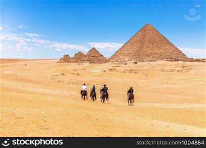 Horse-back riding near the Great Pyramids, Giza, Egypt.. Horse-back riding near the Great Pyramids, Giza, Egypt