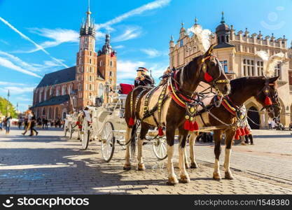 Horse carriages at main square in Krakow in a summer day, Poland