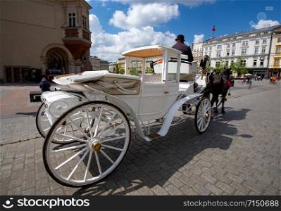 Horse carriages in the old market square. Krakow. Poland.. Krakow. Central Market Square.
