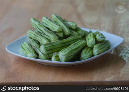 Horse radish tree, Drumstick or Moringa in the plate on wooden table