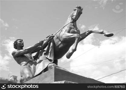 Horse tamers sculpture (1851) by Peter Klodt on Anichkov Bridge in Saint-Petersburg, Russia. Black and white