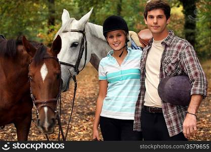 Horseback riders with their horses