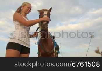 Horseback riding camp vacations girl rider with horse in field