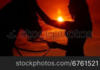 Horseback riding vacations at sunset background