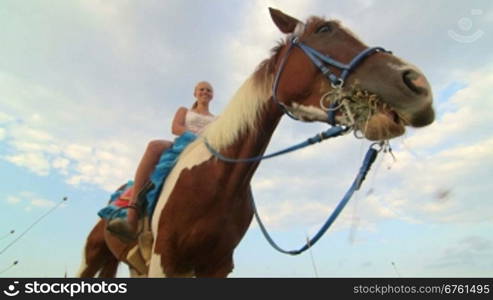 Horseback riding vacations girl rider with her horse in the field