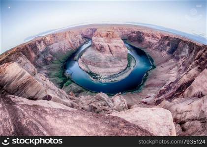 horseshoe bend at sunrise with clear sky and colorado river below