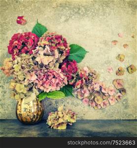 Hortensia flowers bouquet over grungy stone background. Vintage style toned picture