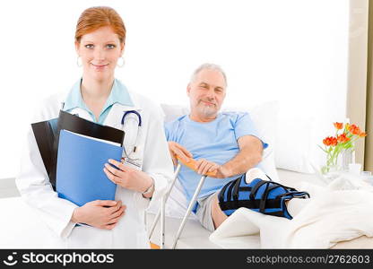 Hospital - female doctor examine senior patient with broken leg