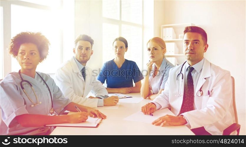 hospital, medical education, health care, people and medicine concept - group of happy doctors meeting at medical office