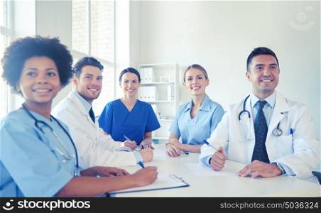 hospital, medical education, health care, people and medicine concept - group of happy doctors meeting at medical office. group of happy doctors meeting at hospital office