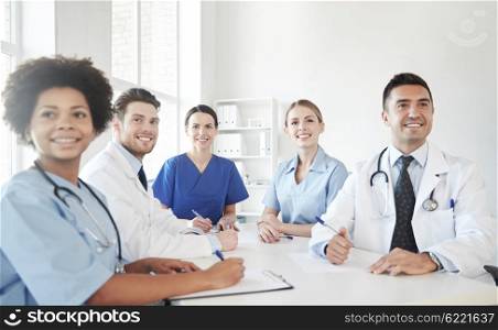 hospital, medical education, health care, people and medicine concept - group of happy doctors meeting at medical office