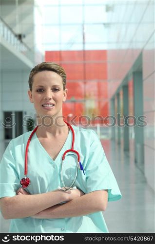 Hospital nurse standing in a corridor