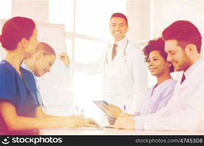 hospital, profession, medical education, people and medicine concept - group of happy doctors meeting on presentation at hospital
