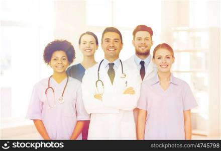 hospital, profession, people and medicine concept - group of happy doctors at hospital