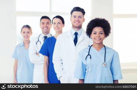 hospital, profession, people and medicine concept - group of happy doctors at hospital. group of happy doctors at hospital