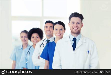 hospital, profession, people and medicine concept - group of happy doctors at hospital. group of happy doctors at hospital