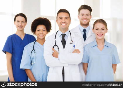 hospital, profession, people and medicine concept - group of happy doctors at hospital