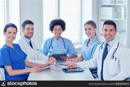 hospital, profession, people and medicine concept - group of happy doctors meeting at medical office