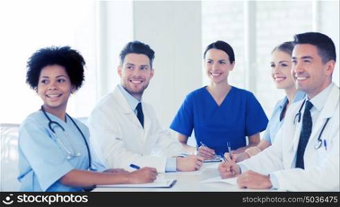 hospital, profession, people and medicine concept - group of happy doctors meeting at medical office. group of happy doctors meeting at hospital office