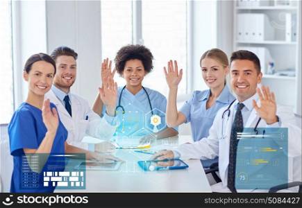 hospital, profession, people and medicine concept - group of happy doctors meeting at medical office. group of happy doctors meeting at hospital office. group of happy doctors meeting at hospital office