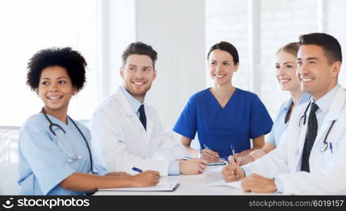 hospital, profession, people and medicine concept - group of happy doctors meeting at medical office