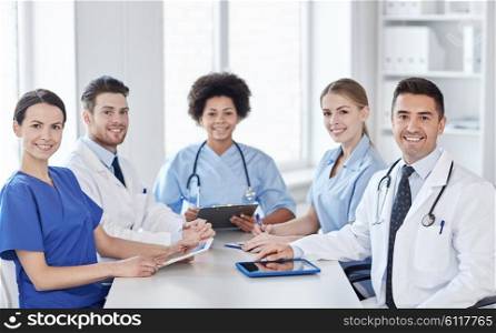 hospital, profession, people and medicine concept - group of happy doctors meeting at medical office