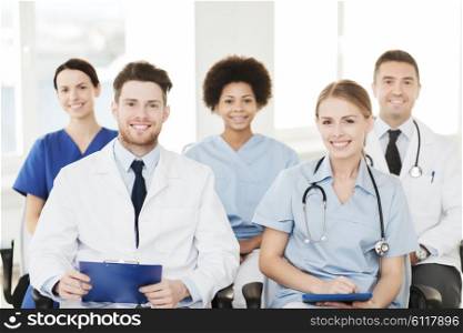 hospital, profession, people and medicine concept - group of happy doctors on seminar in lecture hall at hospital