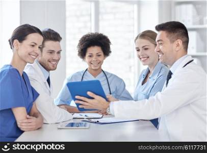 hospital, profession, people and medicine concept - group of happy doctors with tablet pc computers meeting at medical office