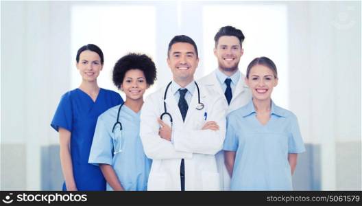 hospital, profession, people and medicine concept - international group of happy doctors at hospital. group of happy doctors at hospital