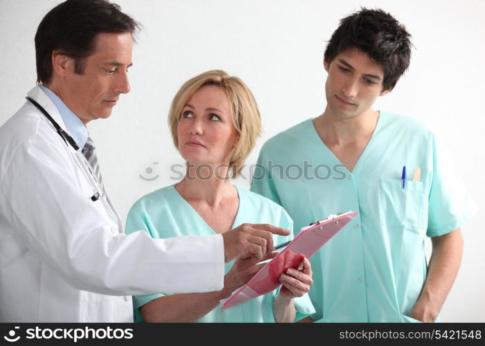 Hospital team reading a chart