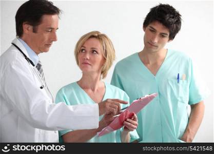 Hospital team reading a chart