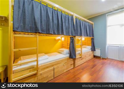 Hostel dormitory beds arranged in room. The hostel dormitory beds arranged in room