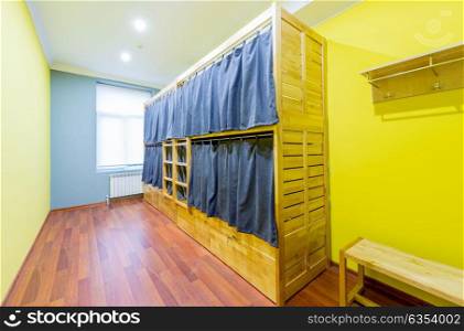 Hostel dormitory beds arranged in room. The hostel dormitory beds arranged in room