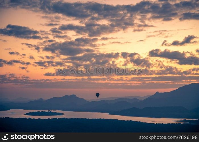Hot air balloon in the sky, beautiful view of amazing cloudy sunset sky over mountains, summer traveling to Sigiriya, Sri Lanka, South Asia
