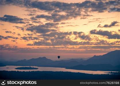 Hot air balloon in the sky, beautiful view of amazing cloudy sunset sky over mountains, summer traveling to Sigiriya, Sri Lanka, South Asia